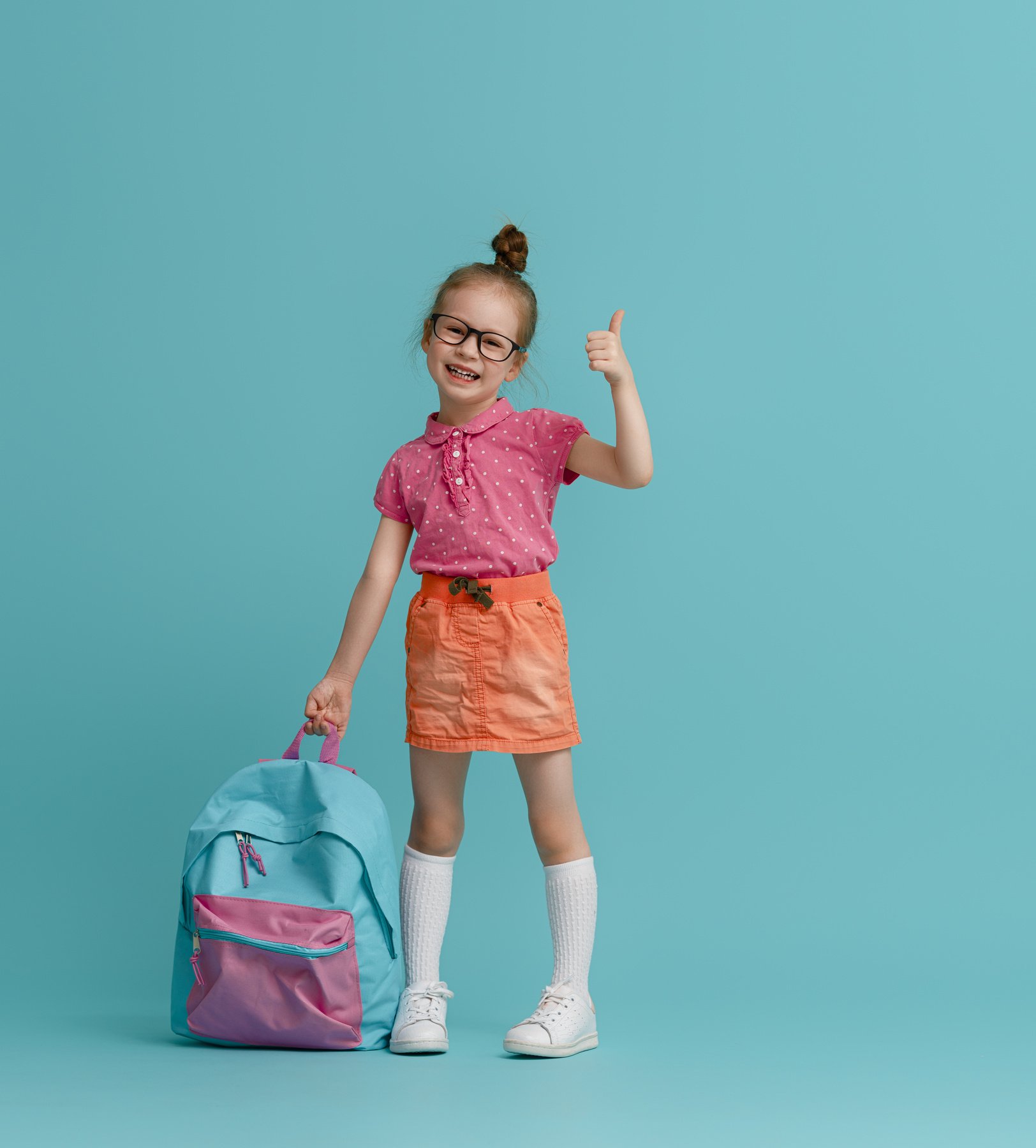 Kid with Backpack on Color Background.